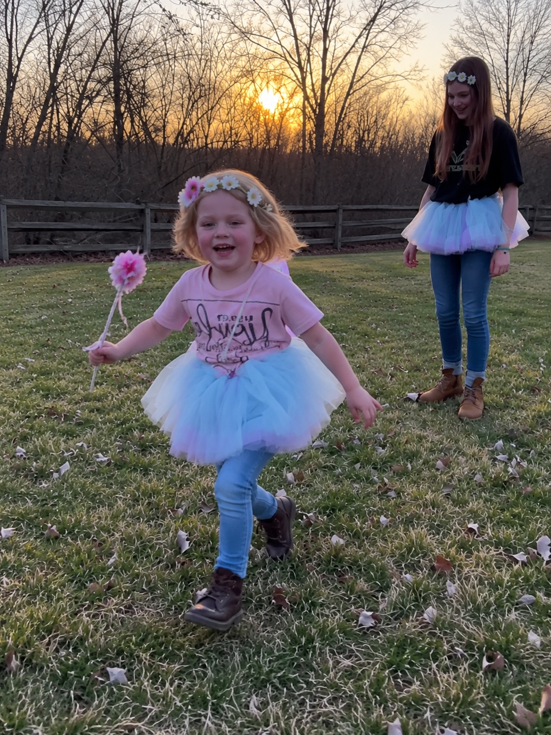 Maple running with a flower wand at golden hour while Ruby watches